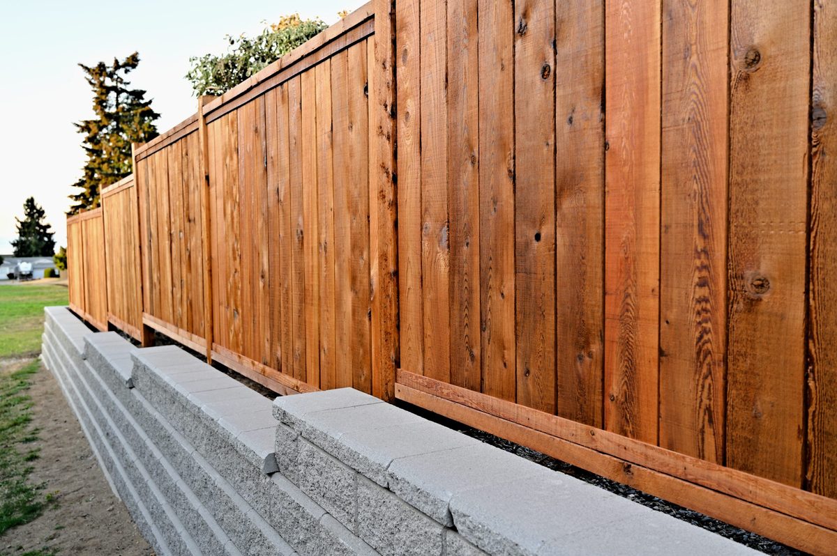 Stone retaining wall and fence from O and M Masonry own website